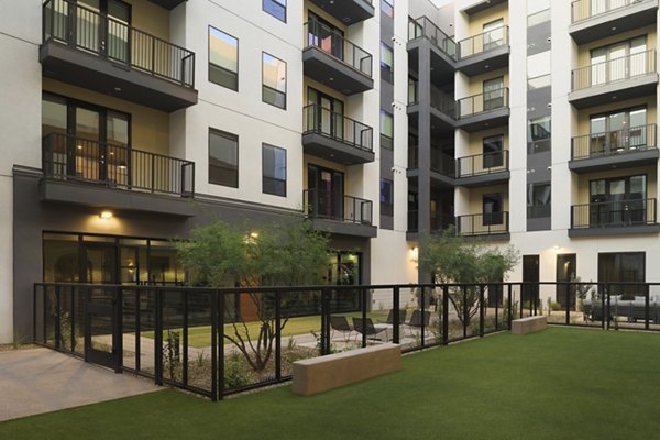 Spacious dog park with agility equipment at Smith + Rio Apartments