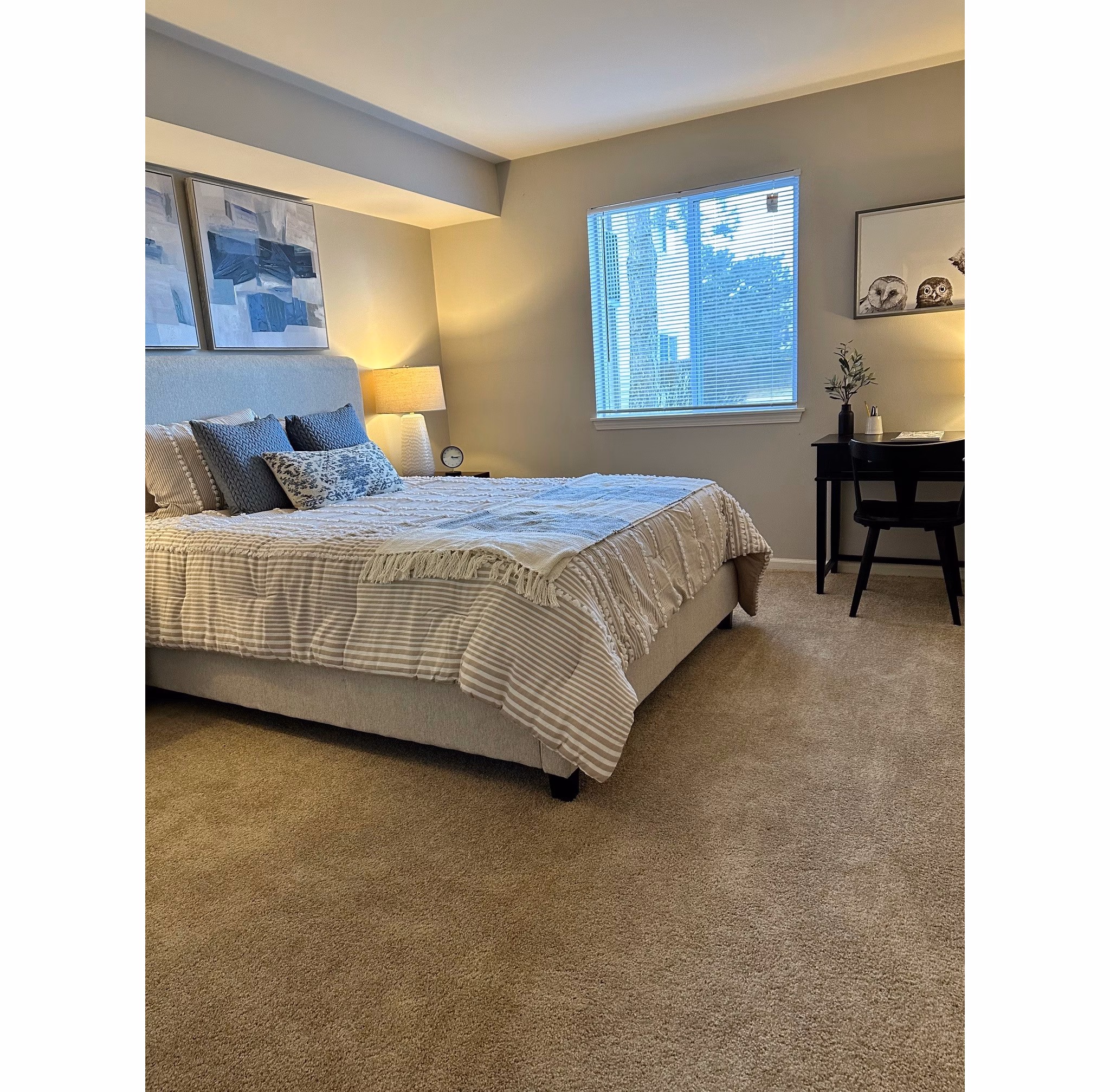 Cozy bedroom with minimalist decor in Fox Pointe Apartments