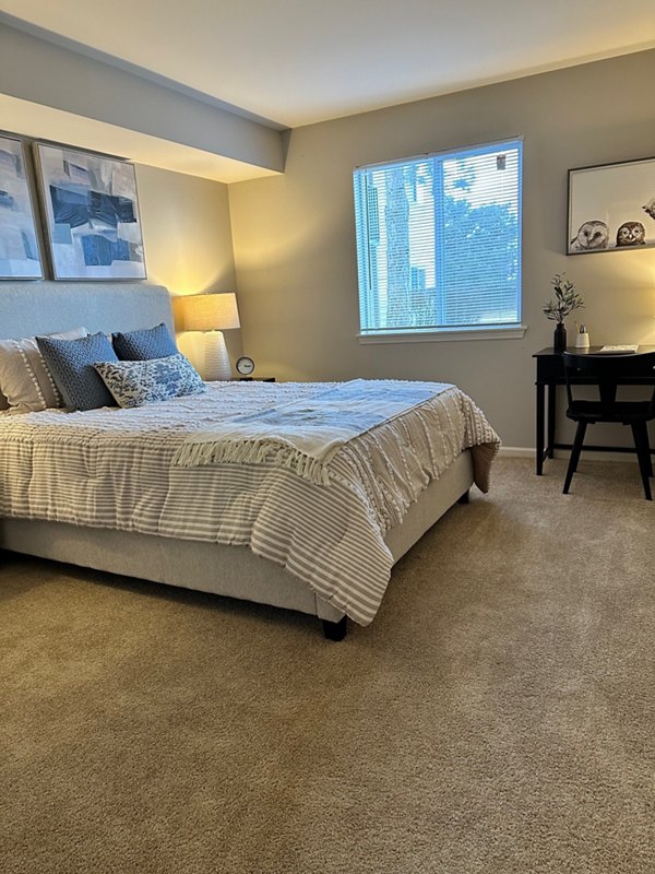 Cozy bedroom with minimalist decor in Fox Pointe Apartments