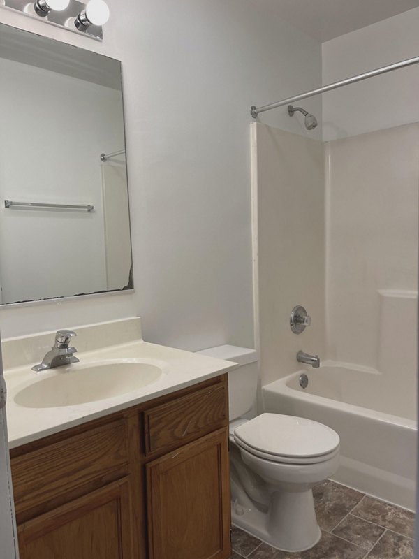 Modern bathroom featuring a sleek vanity and large mirror at Fox Pointe luxury apartments