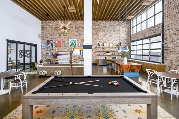 Vibrant clubhouse game room with billiards and modern seating at Soundwater Apartments