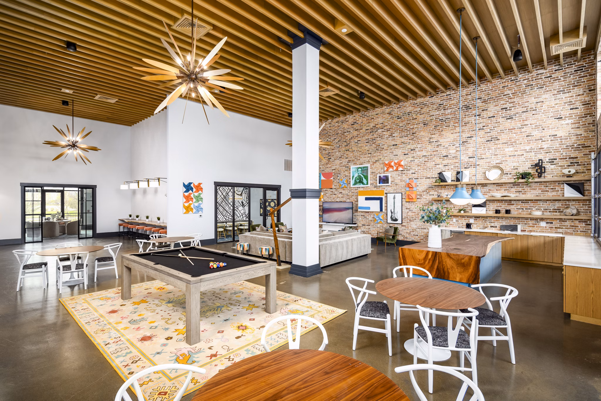 Clubhouse game room with pool table and lounge seating at Soundwater Apartments, luxury living by Greystar in a vibrant community