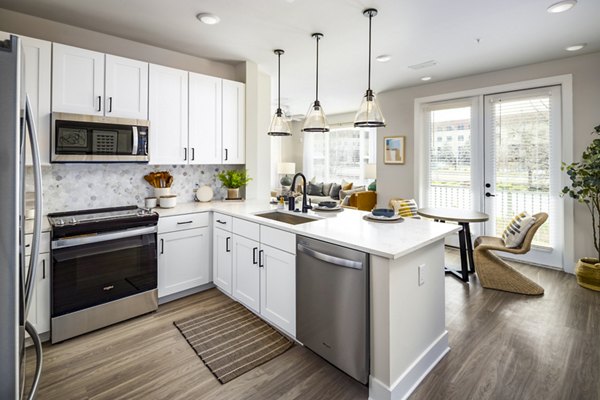 Modern kitchen with stainless steel appliances at Soundwater Apartments