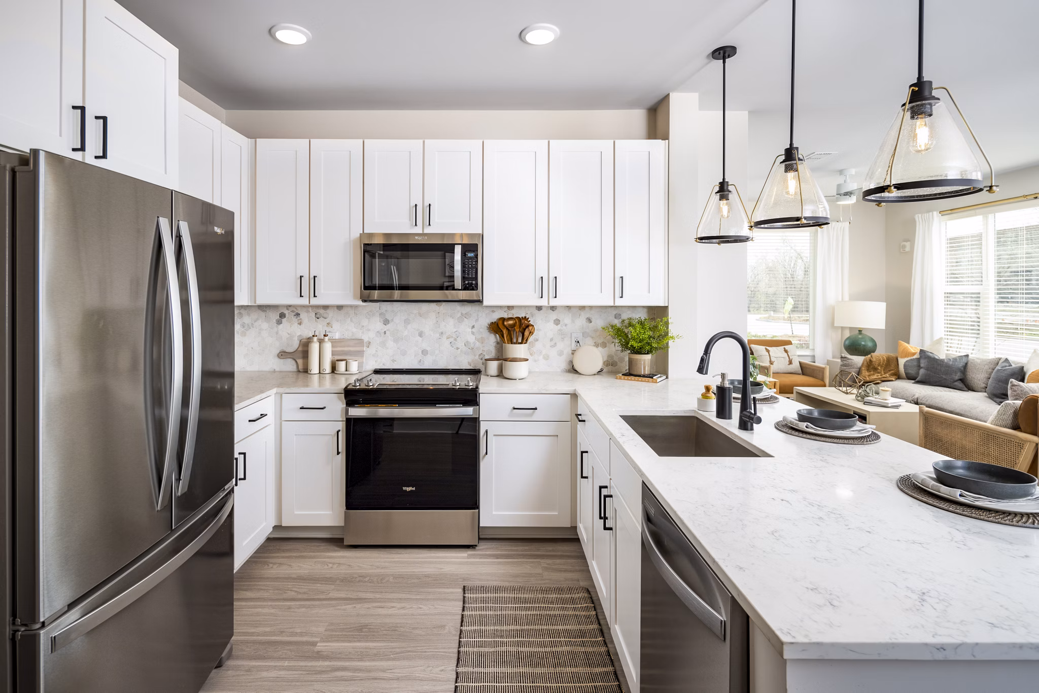 Modern kitchen with stainless steel appliances and island in Soundwater Apartments