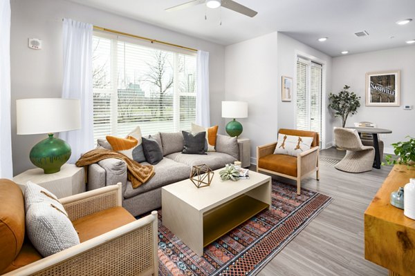 Spacious living room with modern decor in Soundwater Apartments, offering luxury living by Greystar