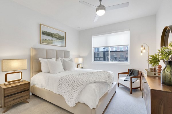 Cozy bedroom with designer furniture at The Dorsey Apartments, Greystar luxury living