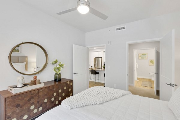 Cozy bedroom featuring a plush queen bed at The Dorsey Apartments in a luxurious setting