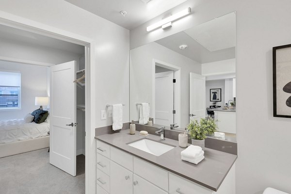 Luxurious bathroom with marble countertops and modern fixtures at The Dorsey Apartments, a Greystar luxury property