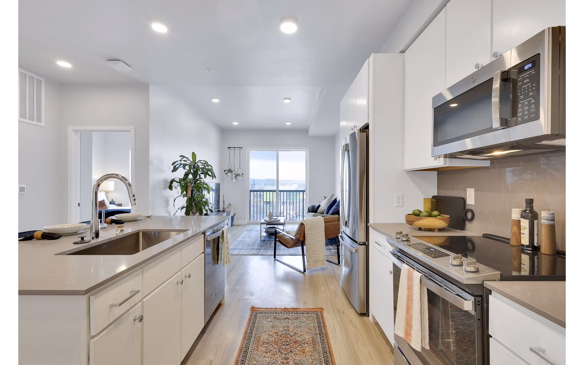 Modern kitchen with sleek countertops and stainless steel appliances at The Dorsey Apartments