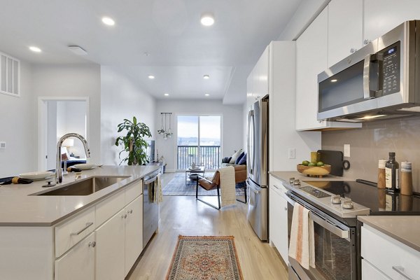 Modern kitchen with sleek countertops and stainless steel appliances at The Dorsey Apartments