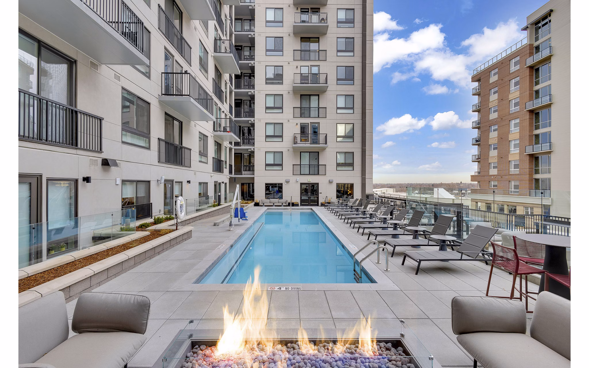 The Dorsey Apartments: Luxury pool with lounge chairs and city views, a highlight of Greystar's upscale living experience in downtown Miami