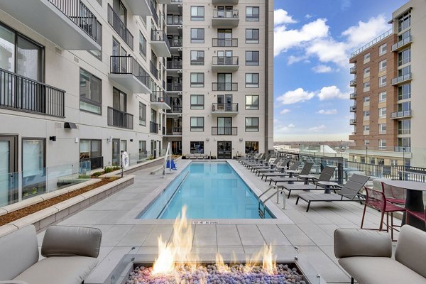 The Dorsey Apartments: Luxury pool with lounge chairs and city views, a highlight of Greystar's upscale living experience in downtown Miami