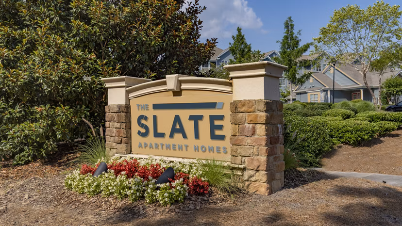 Modern entrance signage at The Slate Apartments, showcasing luxury urban living in the heart of the city