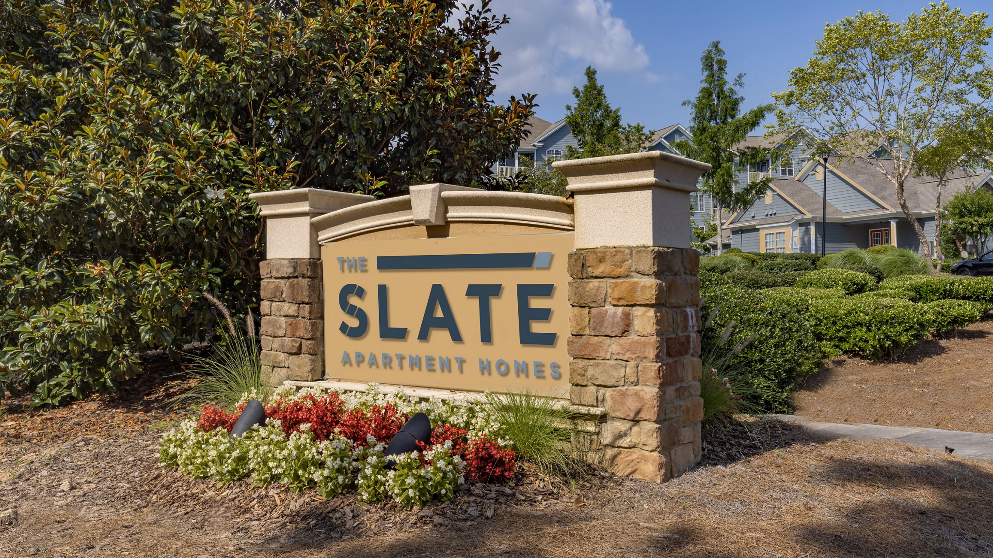 Modern entrance signage at The Slate Apartments, showcasing luxury urban living in the heart of the city