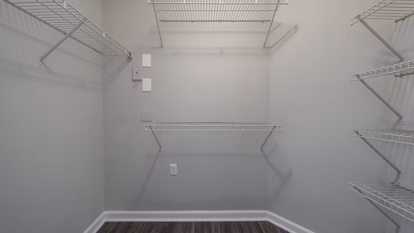 Walk-in closet with ample shelving and storage space at The Slate Apartments