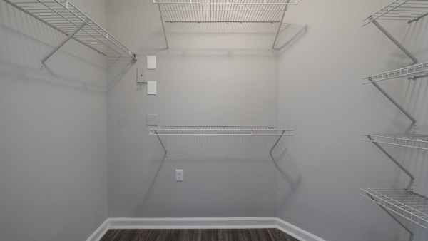 Walk-in closet with ample shelving and storage space at The Slate Apartments