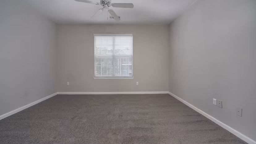 Luxurious bedroom with large windows at The Slate Apartments