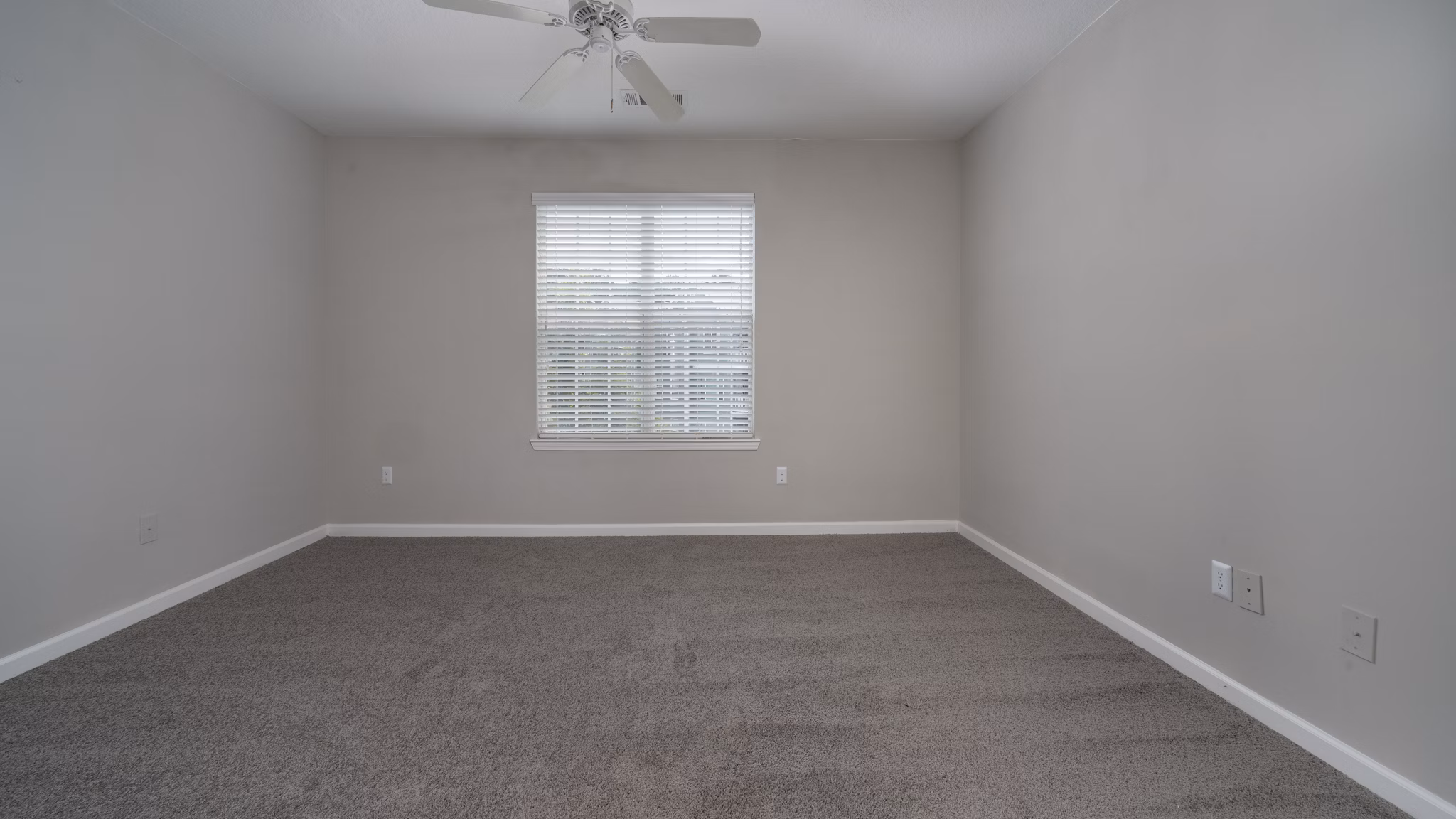 Luxurious bedroom with large windows at The Slate Apartments