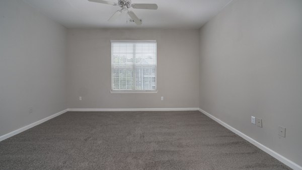 Luxurious bedroom with large windows at The Slate Apartments