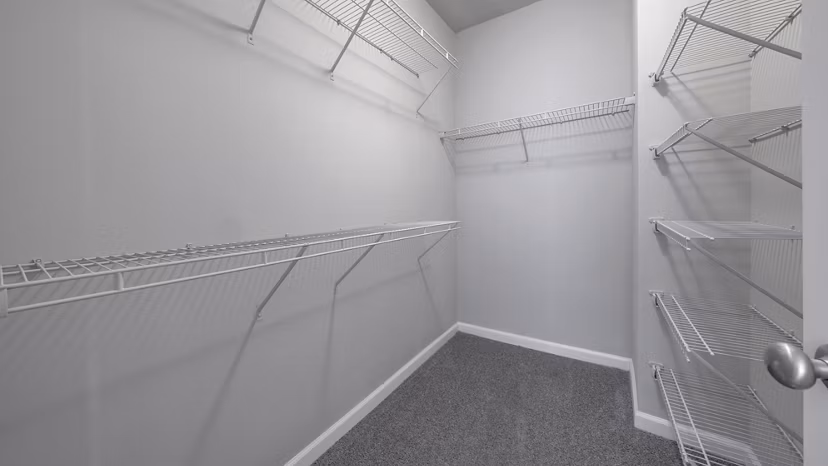 Walk-in closet with ample storage space at The Slate Apartments