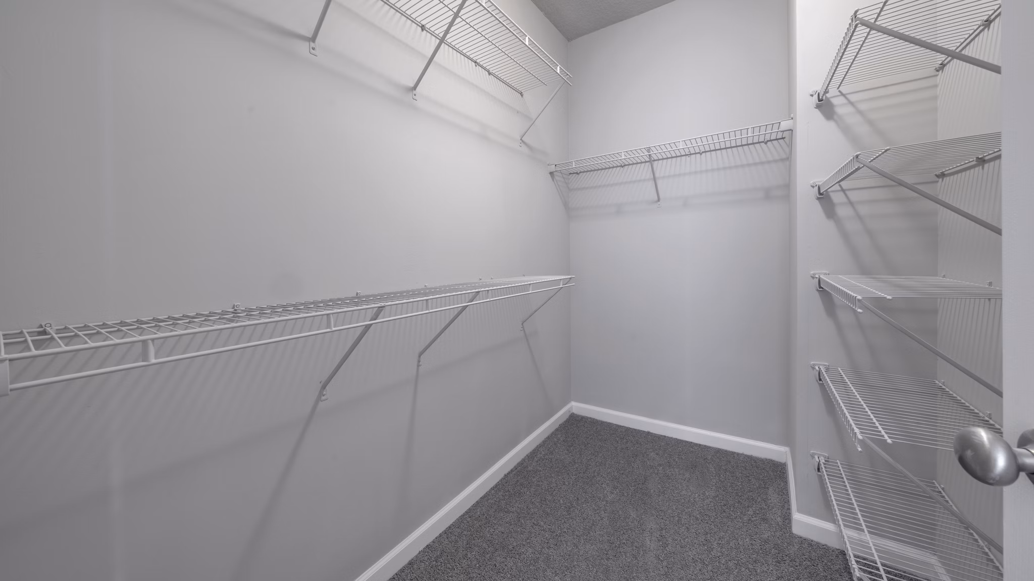 Walk-in closet with ample storage space at The Slate Apartments