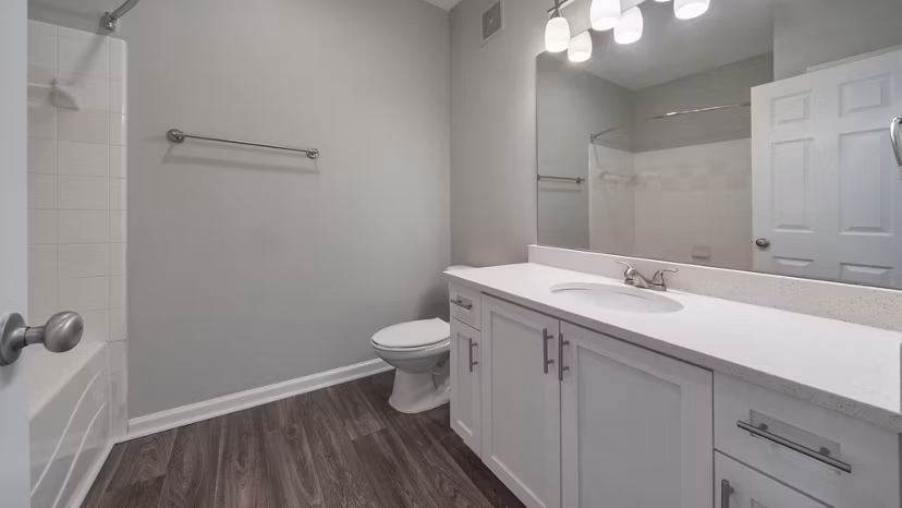 Modern bathroom with sleek fixtures and tiled walls at The Slate Apartments