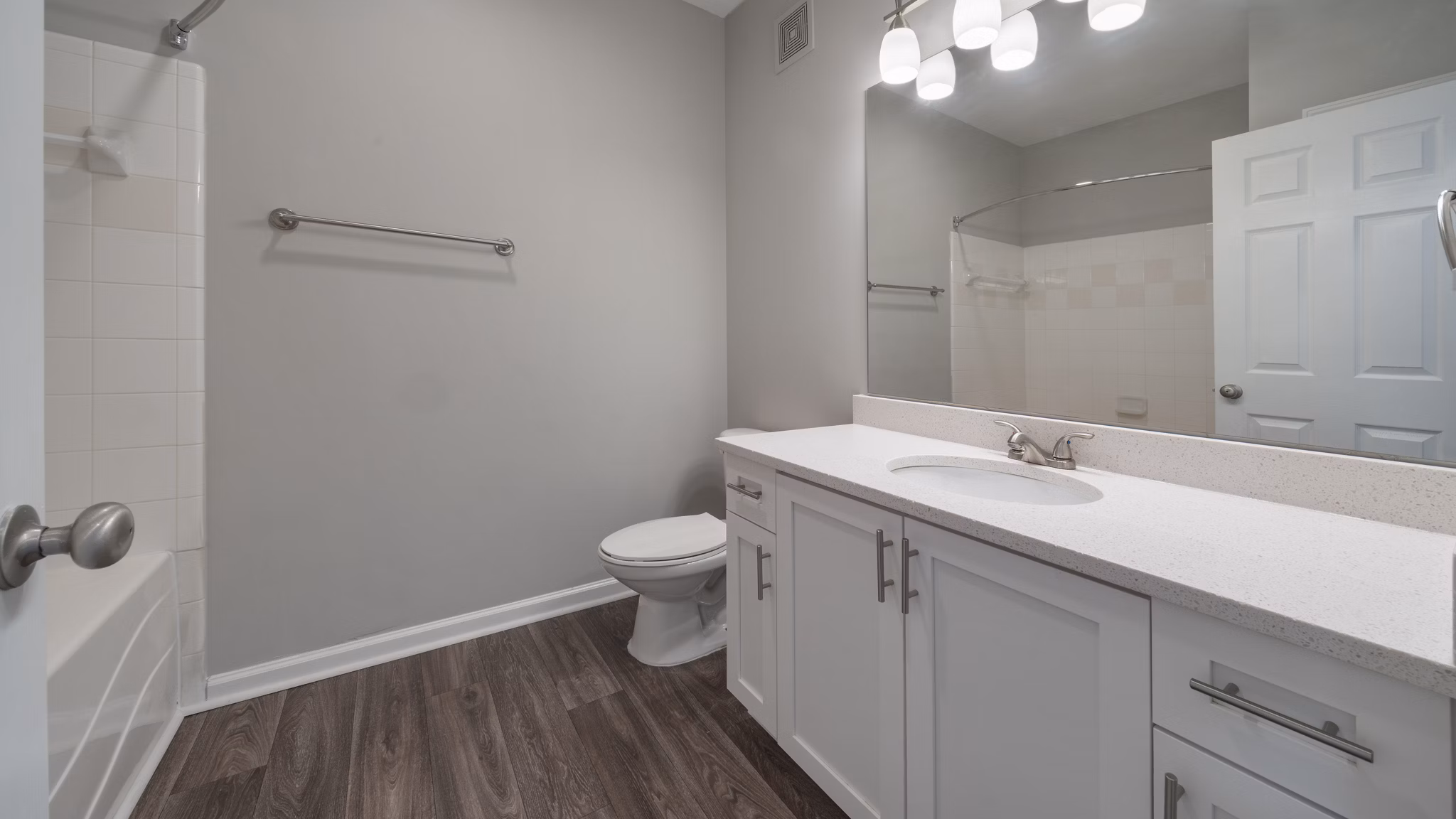 Modern bathroom with sleek fixtures and tiled walls at The Slate Apartments