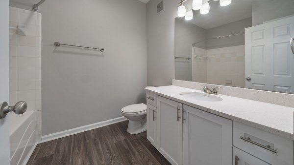 Modern bathroom with sleek fixtures and tiled walls at The Slate Apartments