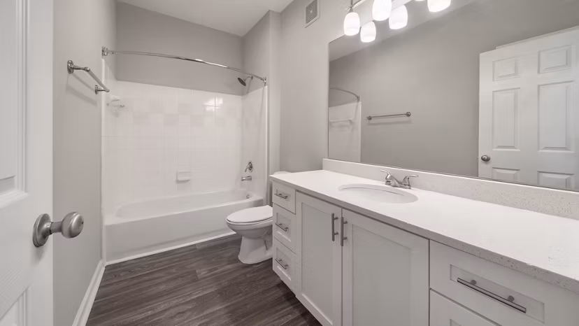 Luxurious bathroom featuring marble countertops and dual sinks at The Slate Apartments