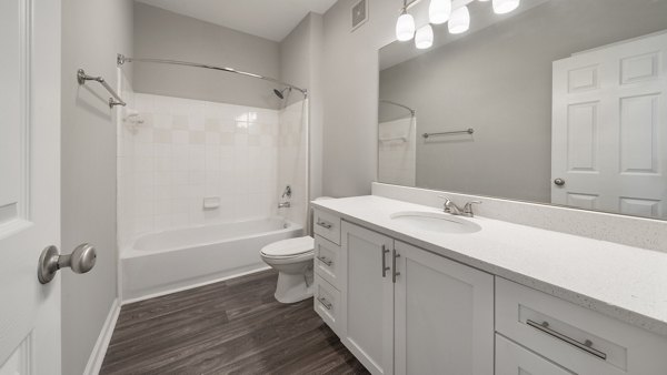 Luxurious bathroom featuring marble countertops and dual sinks at The Slate Apartments