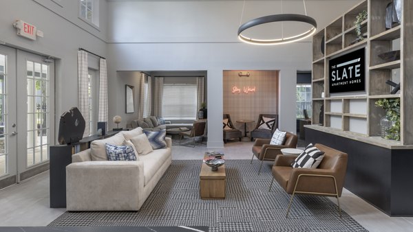 Clubhouse with modern design featuring lounge seating and billiards at The Slate Apartments, a luxury Greystar community