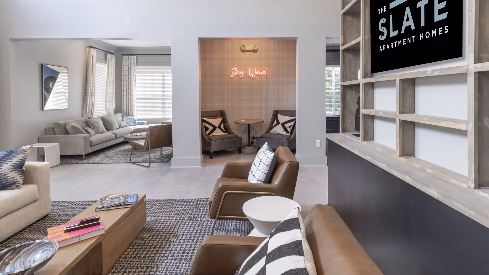 Clubhouse featuring modern lounge seating and large-screen TV at The Slate Apartments in luxury Greystar community