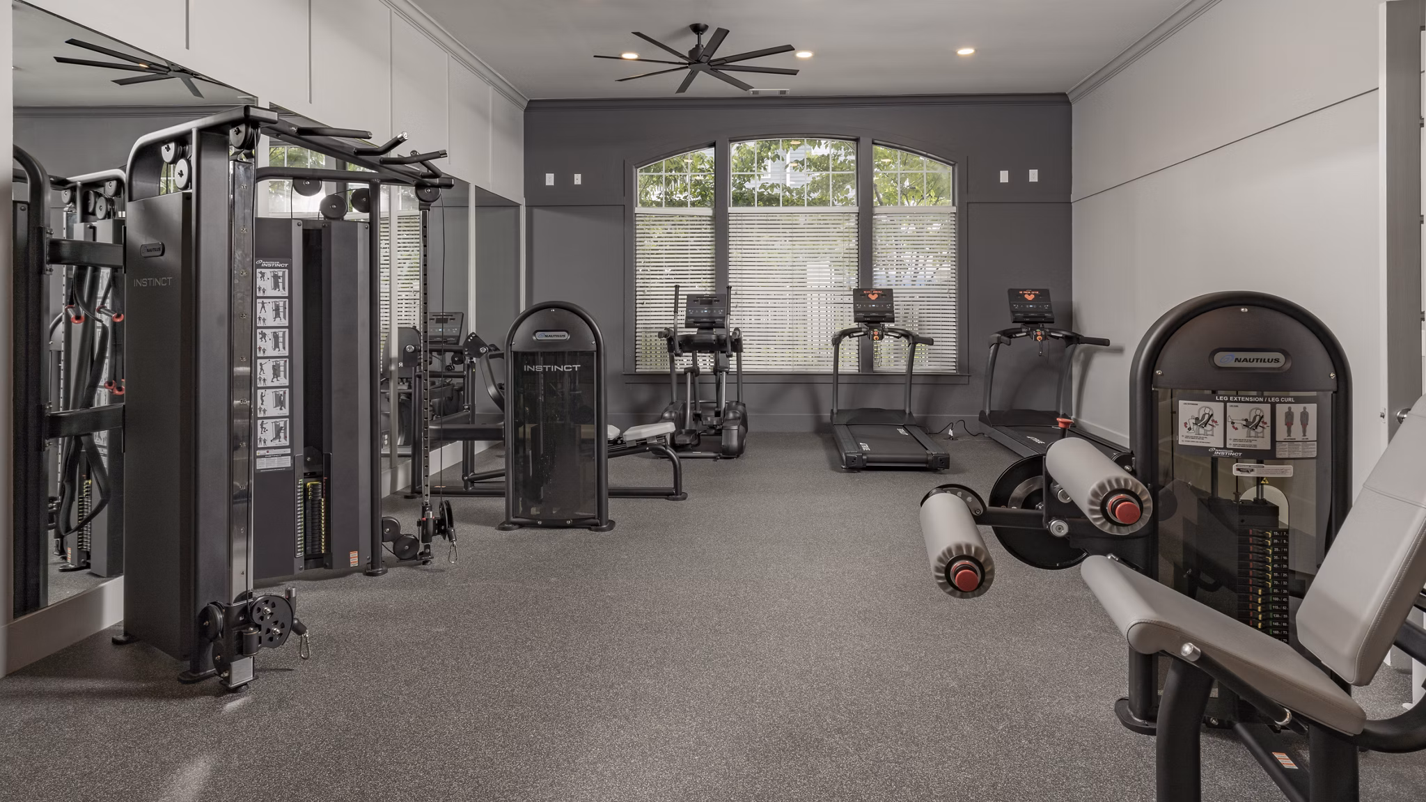 Fully-equipped fitness center with modern machines at The Slate Apartments