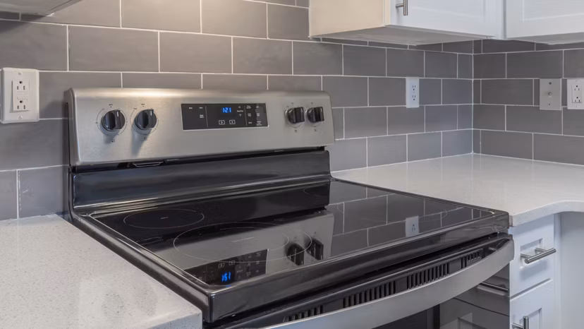 Modern kitchen with stainless steel appliances at The Slate Apartments