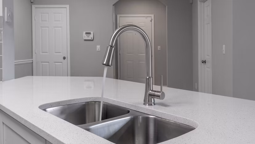 Modern kitchen with stainless steel appliances at The Slate Apartments