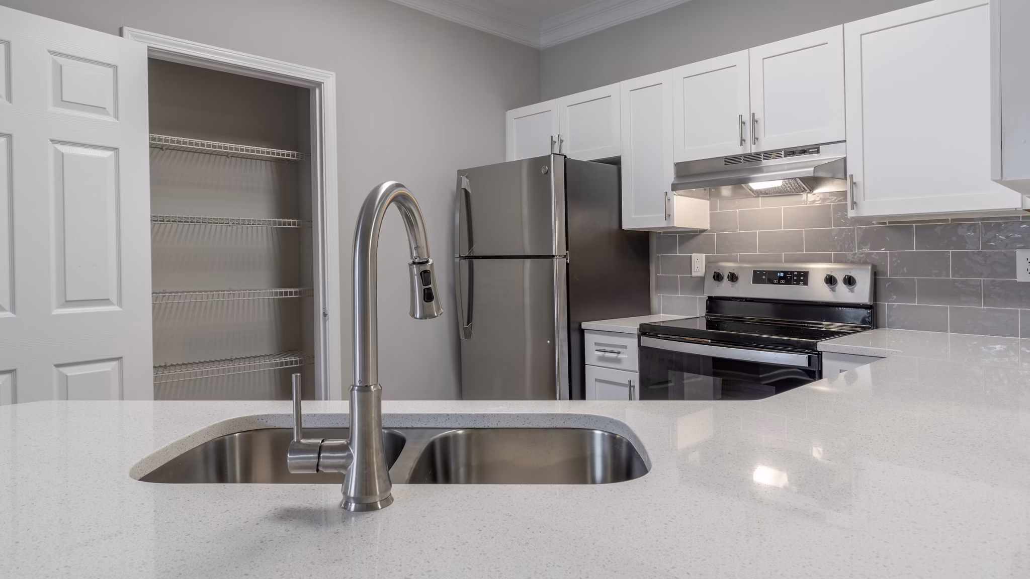Modern kitchen with stainless steel appliances and granite countertops in The Slate Apartments