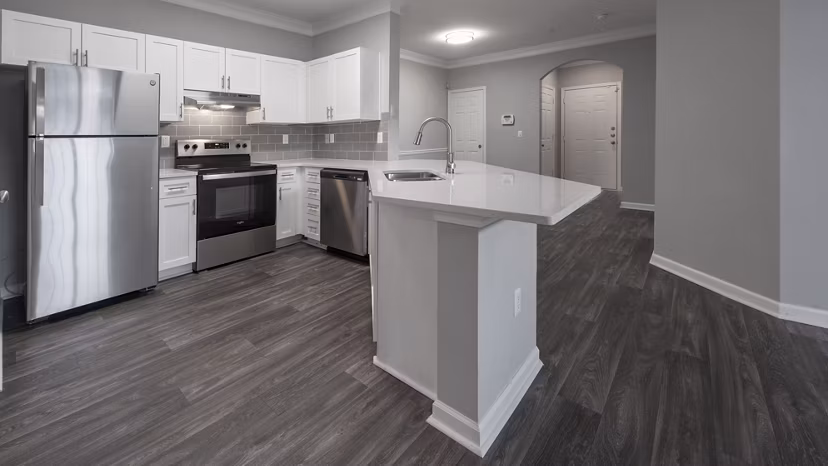 Modern kitchen with stainless steel appliances and quartz countertops at The Slate Apartments Perfect for luxury living
