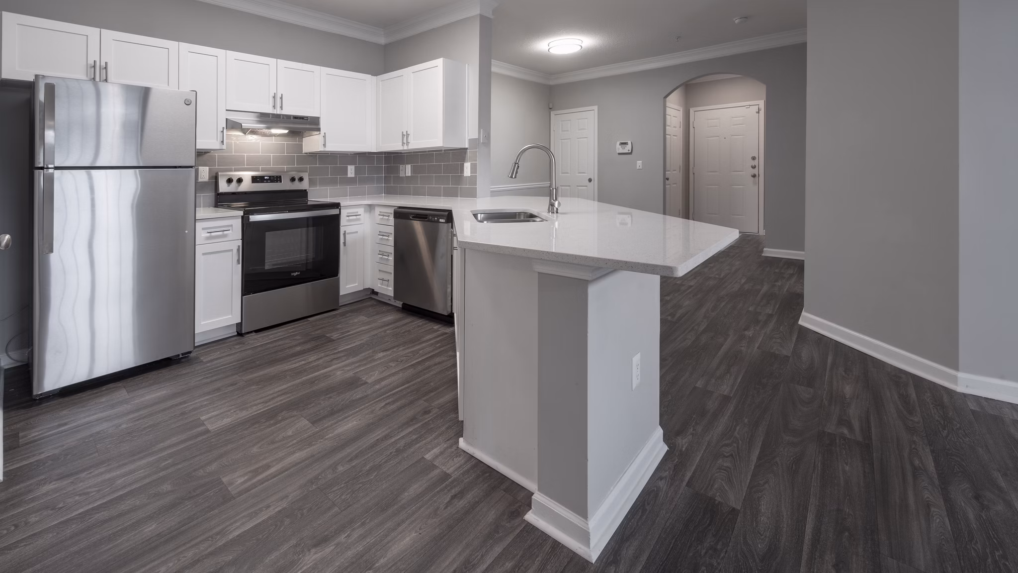 Modern kitchen with stainless steel appliances and quartz countertops at The Slate Apartments Perfect for luxury living