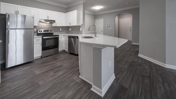 Modern kitchen with stainless steel appliances and quartz countertops at The Slate Apartments Perfect for luxury living