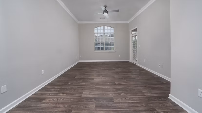 Cozy living room with stylish decor and large windows at The Slate Apartments