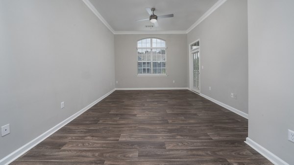 Cozy living room with stylish decor and large windows at The Slate Apartments