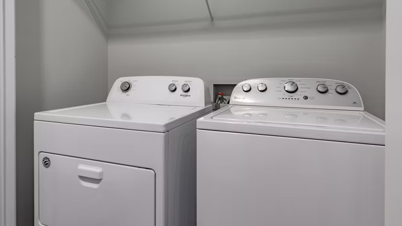 Laundry room with modern appliances in The Slate Apartments, a Greystar luxury community
