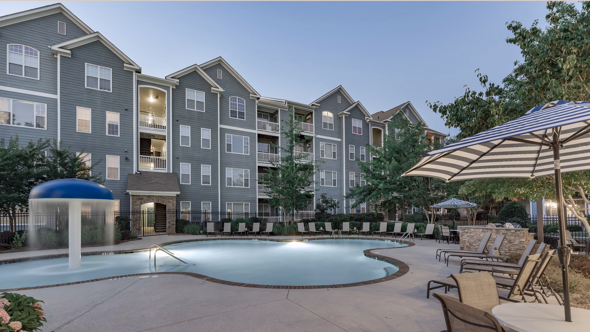 Resort-style outdoor pool with lounge chairs at The Slate Apartments, a Greystar luxury living community