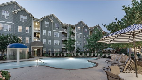 Resort-style outdoor pool with lounge chairs at The Slate Apartments, a Greystar luxury living community