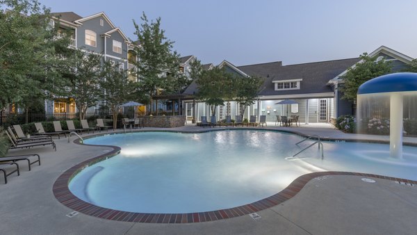 Luxurious outdoor pool at The Slate Apartments with stylish lounge areas, perfect for relaxation and social gatherings