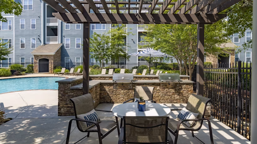 Outdoor grill area with seating at The Slate Apartments, offering a perfect spot for barbecues and social gatherings