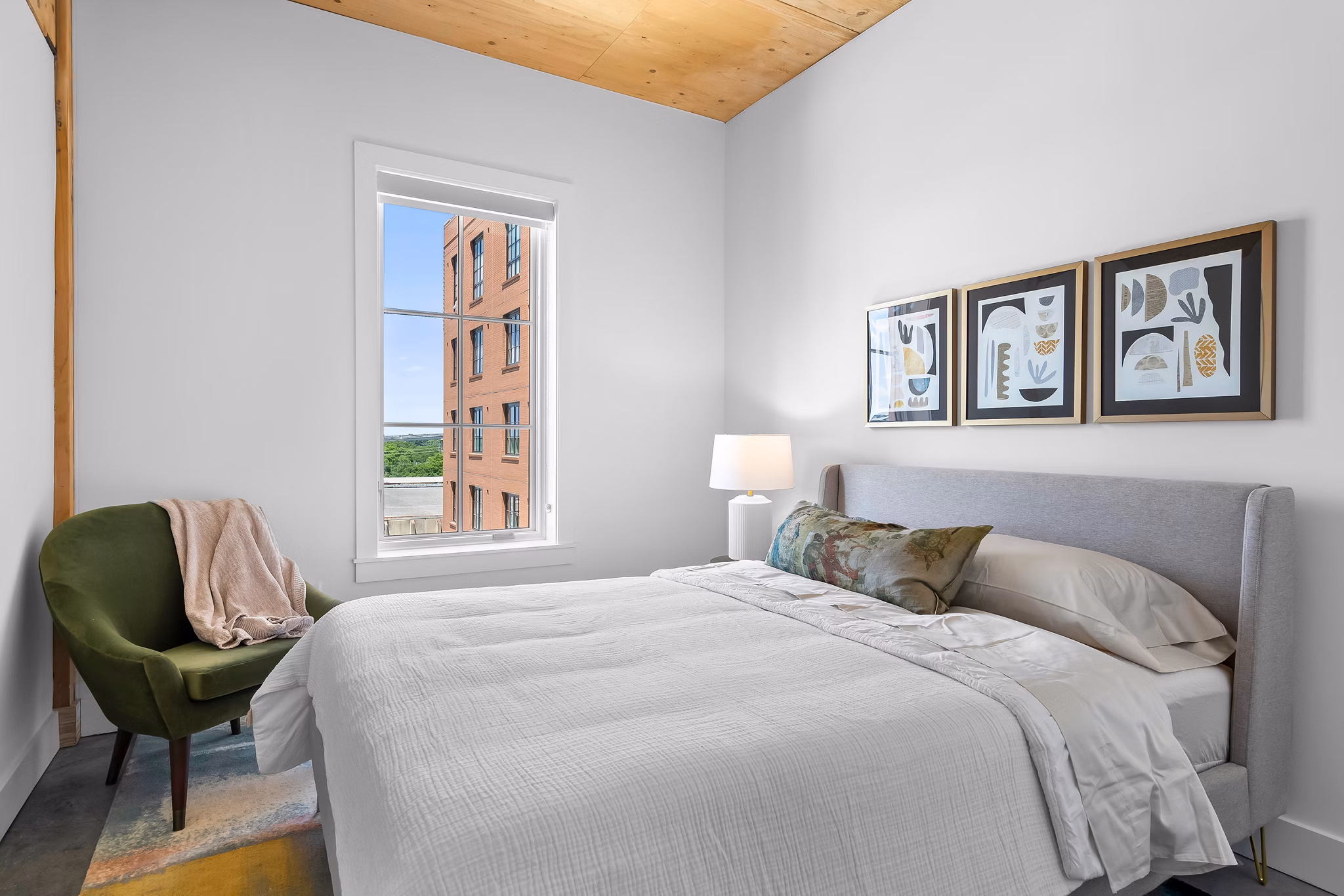 Cozy bedroom with modern furnishings in Ann Street Lofts Apartments, perfect for luxury living in a vibrant urban setting