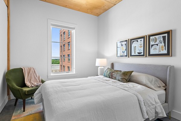 Cozy bedroom with modern furnishings in Ann Street Lofts Apartments, perfect for luxury living in a vibrant urban setting