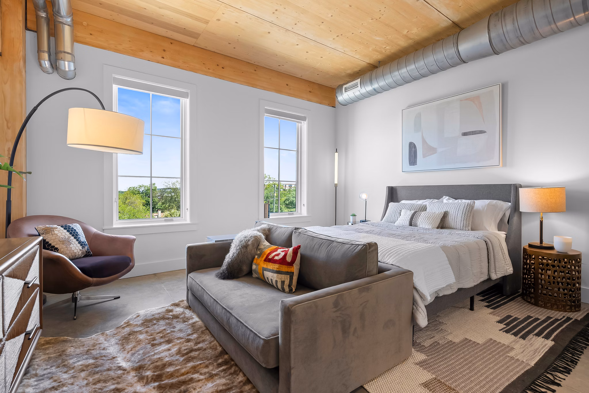 Cozy bedroom with modern furnishings at Ann Street Lofts Apartments