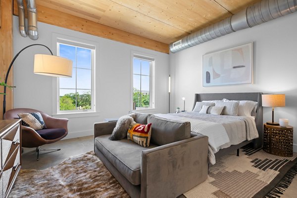 Cozy bedroom with modern furnishings at Ann Street Lofts Apartments